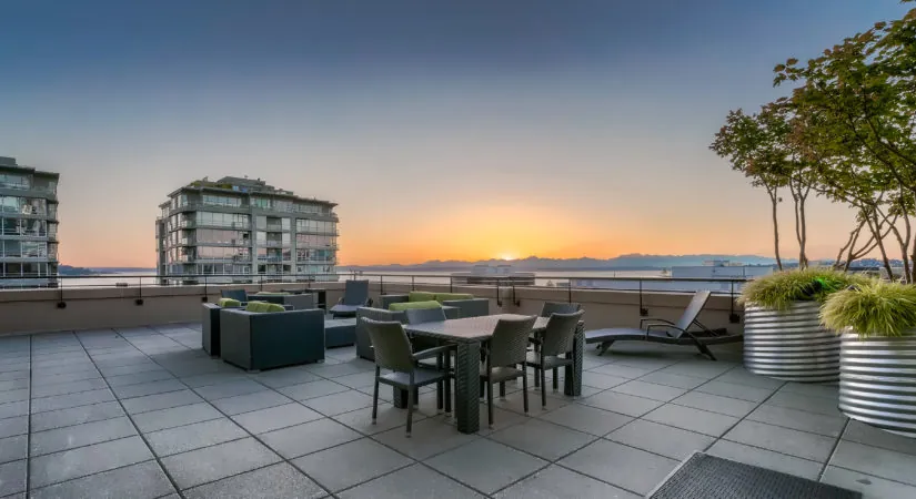 Rooftop deck at Gallery Belltown Condominiums at sunset, looking west over Puget Sound to the Olympic Mountains, sold by Special Agents Realty