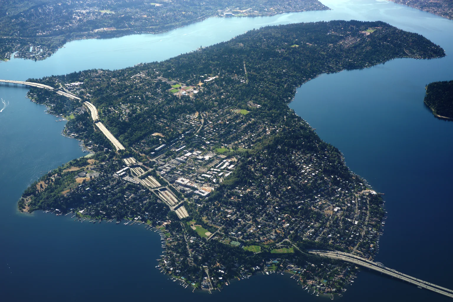 Aerial view of Mercer Island ringed by Lake Washington, with the I-90 bridge crossing its north end