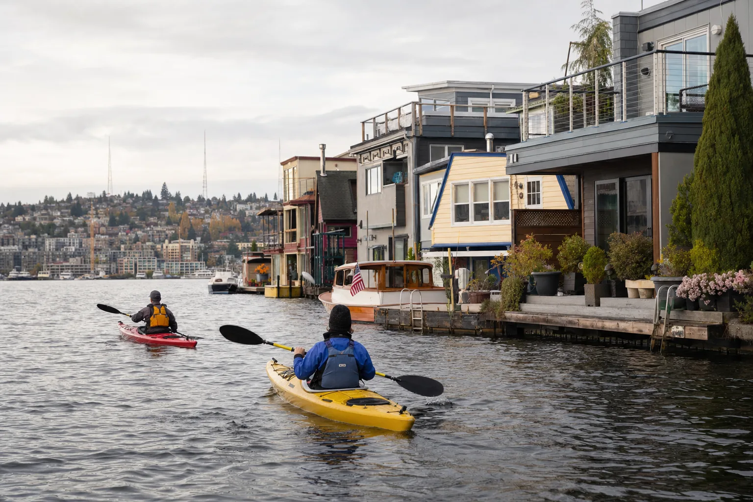 Kayakers paddling past docks on Lake Union